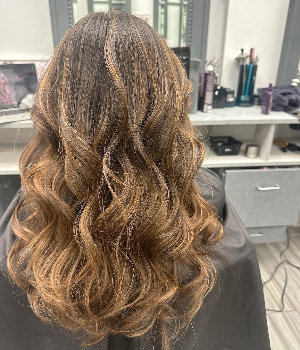 picture of a client with hair curled at Salon Essential